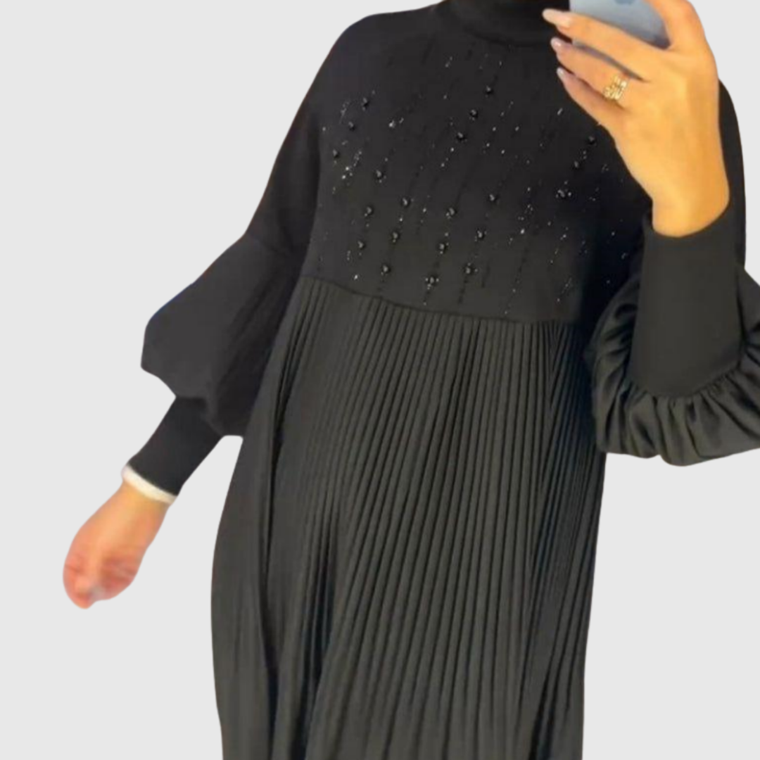 Elodie black gown detail showing high neckline and pleated skirt