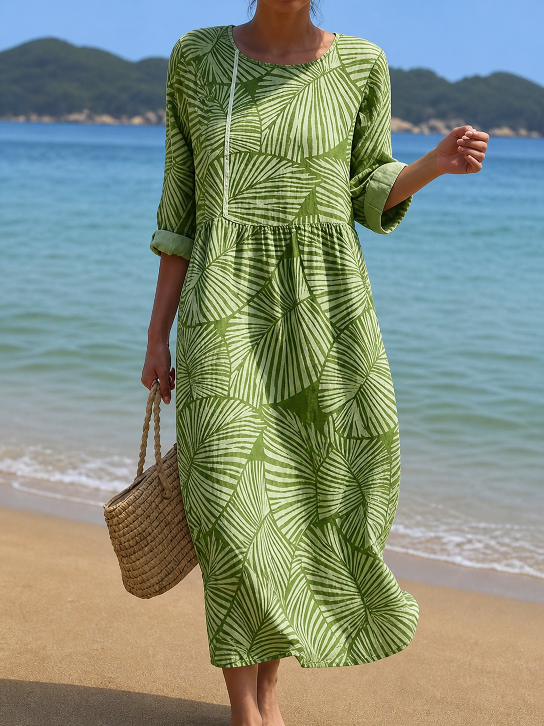 Palm-print midi beach dress in green, full-length front view on the beach