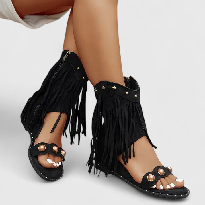 Giselina fringed sandals in black, worn three-quarter view