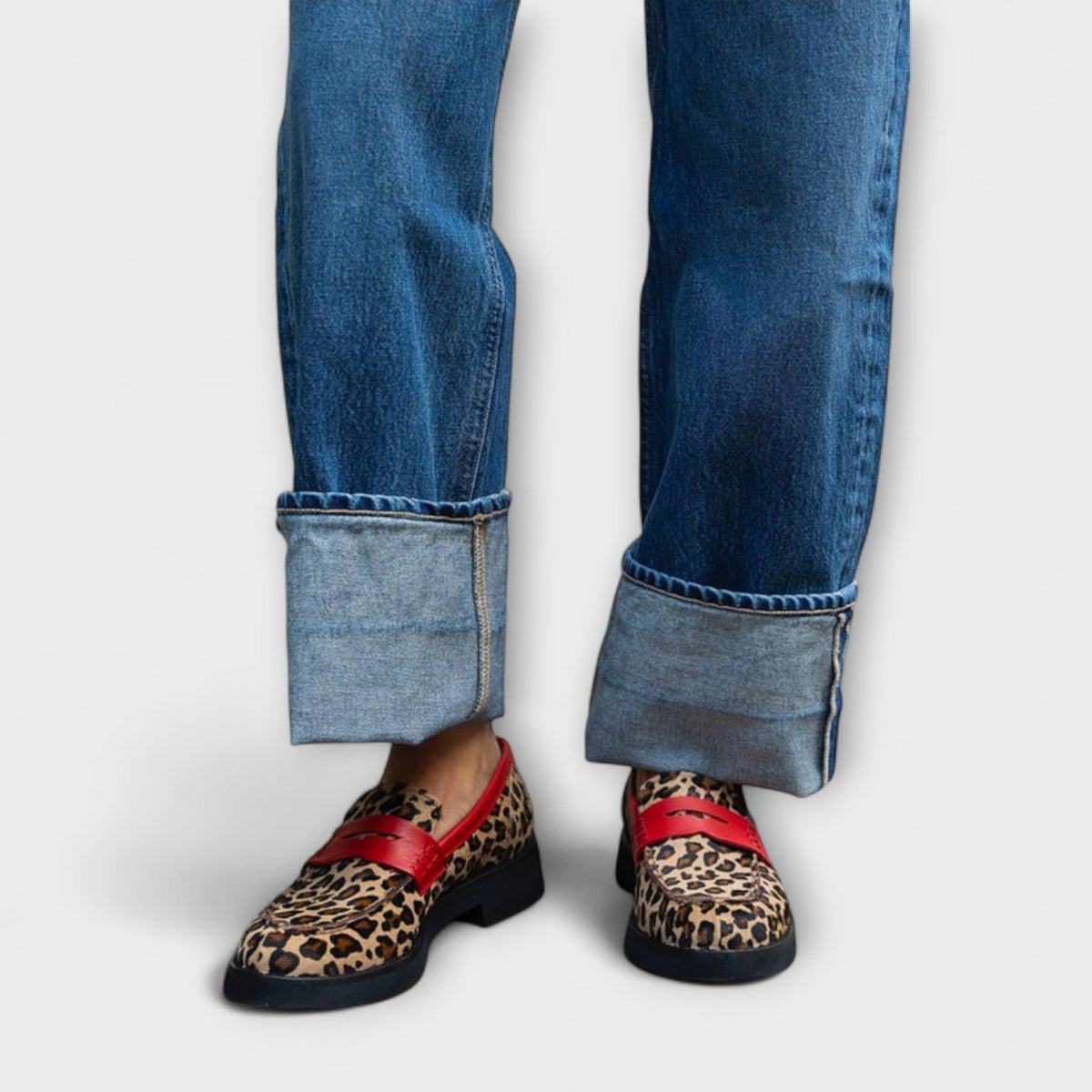 Sabine leopard print loafers with red strap, worn with turned-up jeans