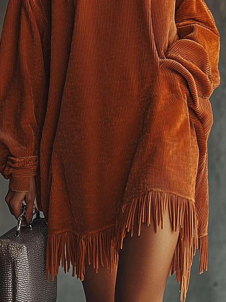 Mira corduroy dress in burnt orange, detail of fringed asymmetric hem