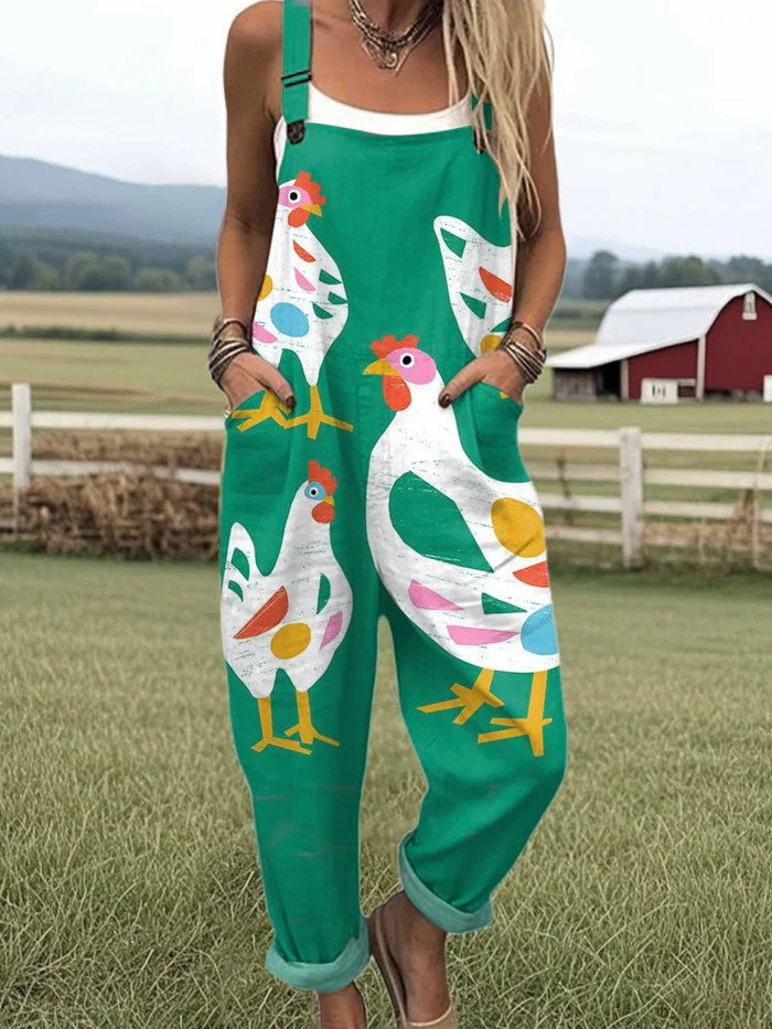 Whimsical hen-print dungarees in green, full-length front view with front pockets