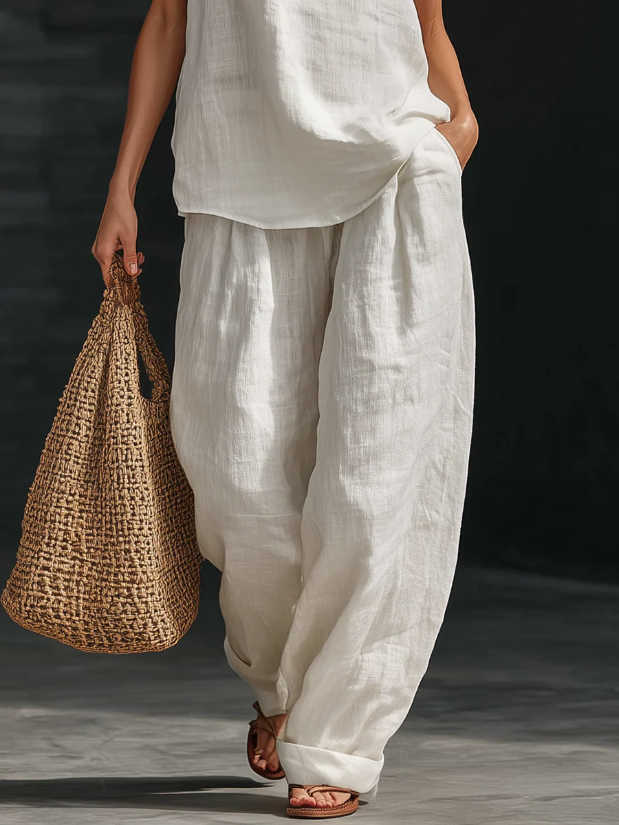 Noreen halter wide-leg set in white, close-up of wide-leg trousers with cuffed hems