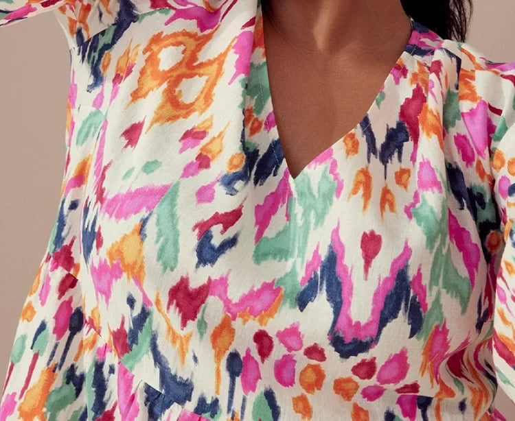 Isabella dress close-up of V-neckline and painterly ikat print