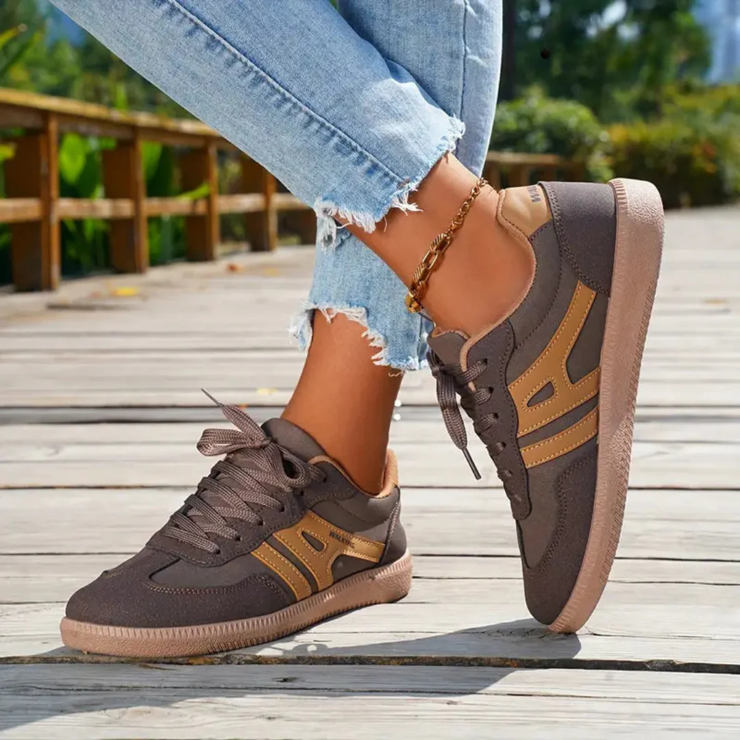 Ceridwen lace-up trainers in brown with tan stripes, worn side view