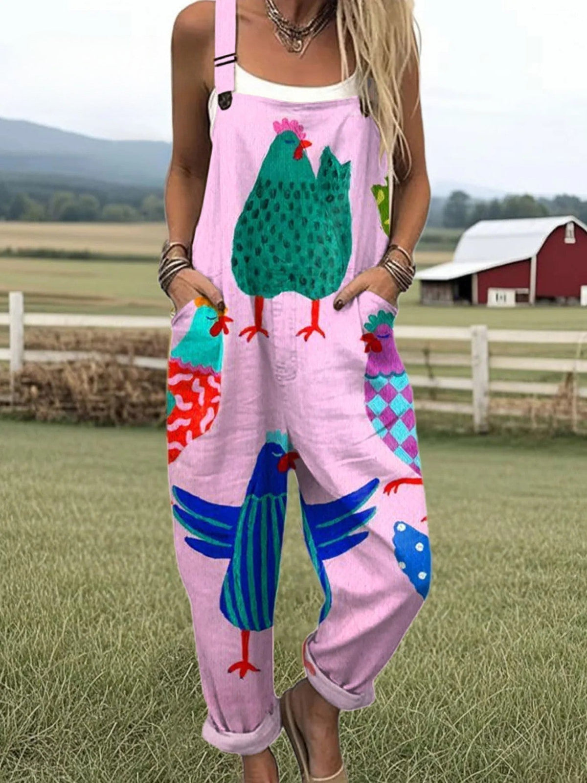 Sunny Coop dungarees in pink with painted chicken print, full-length front view