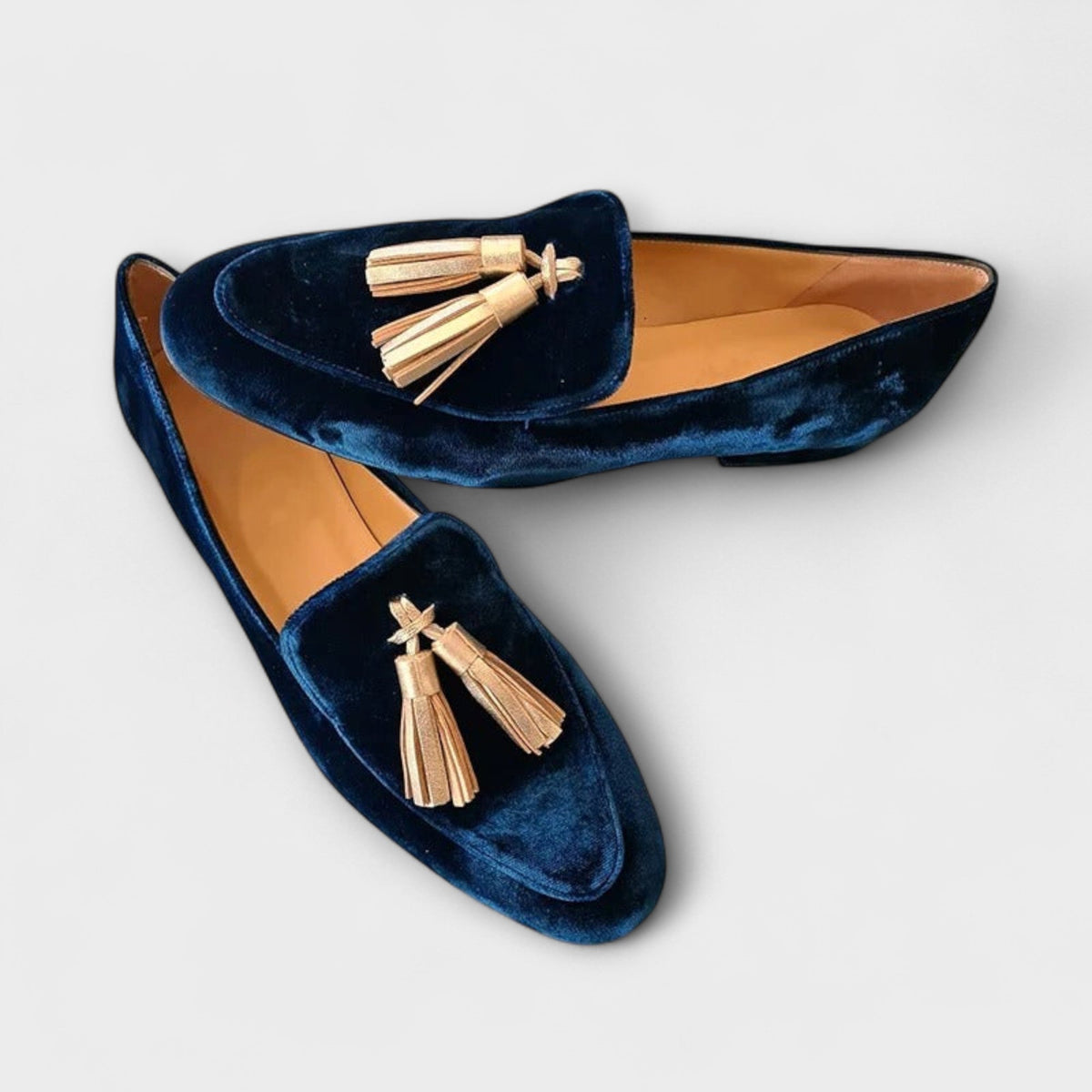 Celeste navy tassel loafers, angled product view showing flat sole