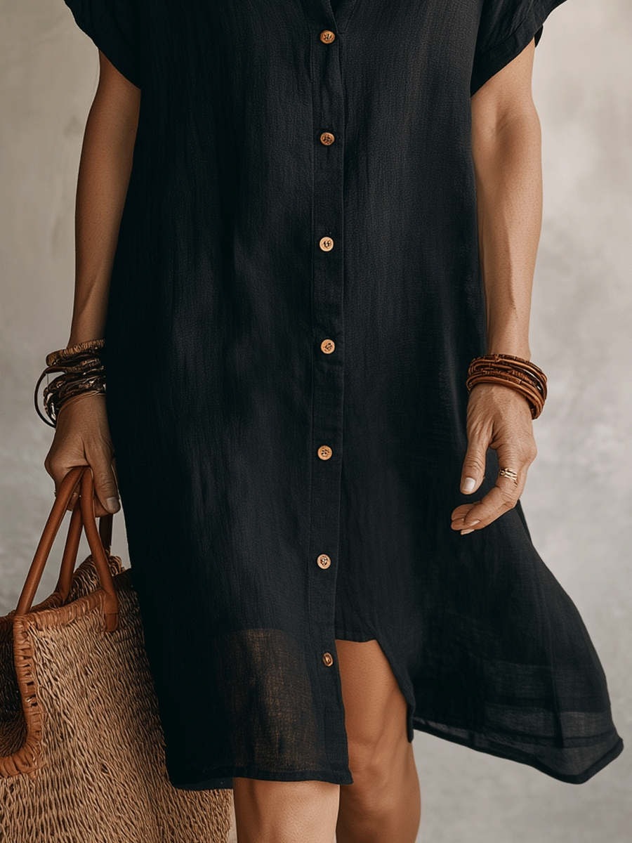 Close-up of black linen midi dress stepped hem and side slit
