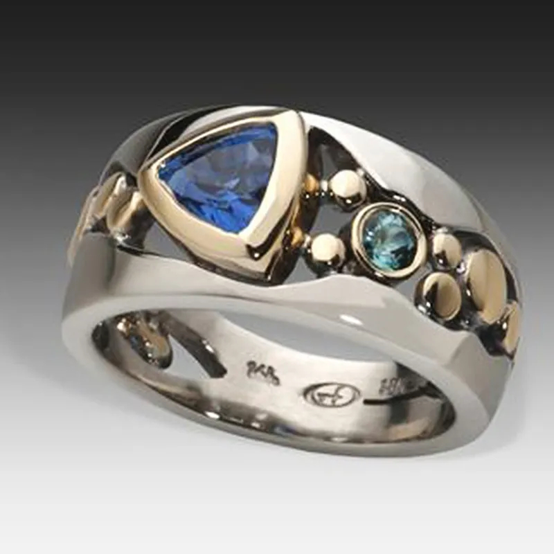 Blue crystal ring with gold bezel, teal accent stone and two-tone beaded band