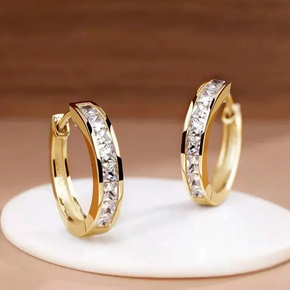 Crystal and gold hoop earrings with square-cut stones, close-up side view