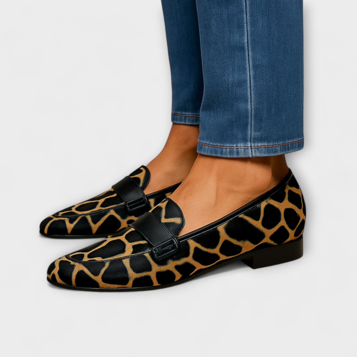 Estelle streamlined loafers in black and tan animal print, worn side view