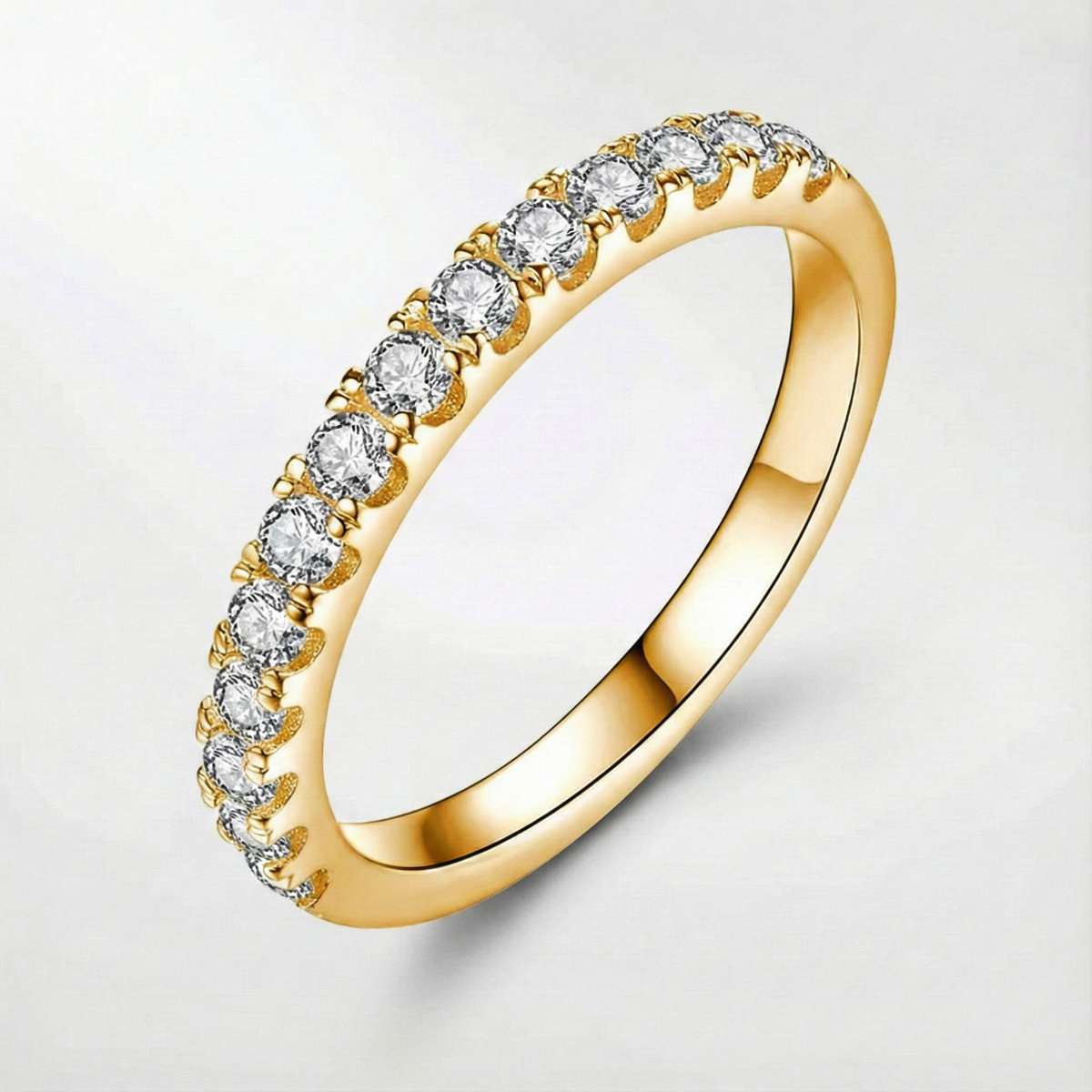 Moissanite ring in gold tone with a row of round stones, side view