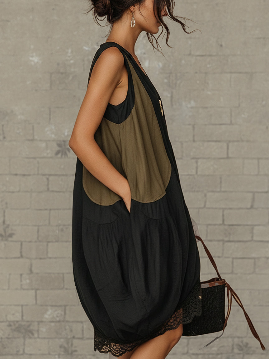 Inès tulip mini dress in black, side view with hands in front pockets