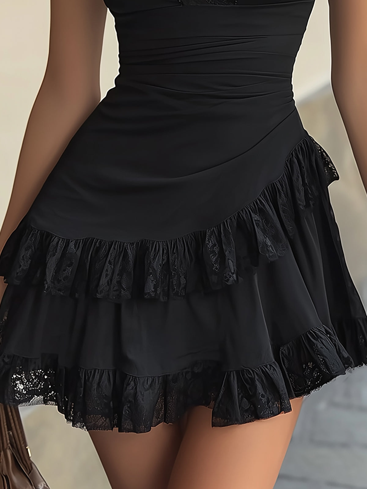 Estelle black mini dress detail of tiered lace-edged ruffle skirt