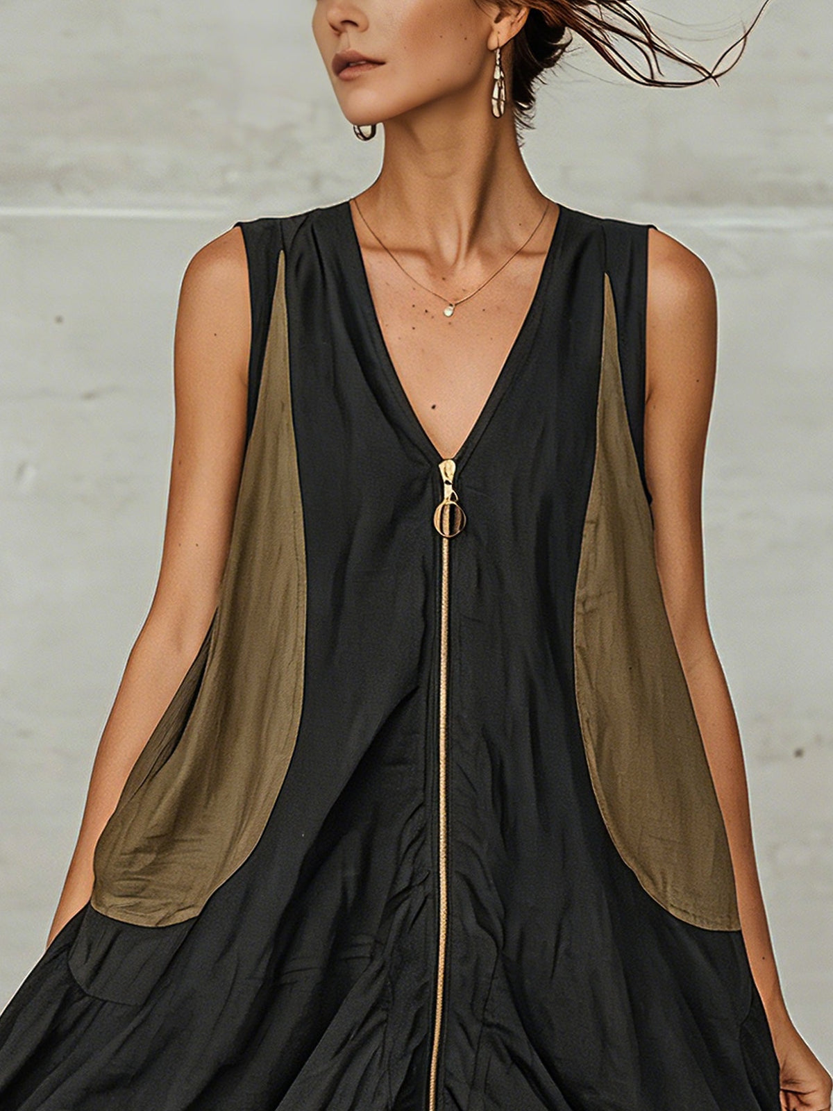 Close-up of deep V neckline and gold front zip on the Inès mini dress