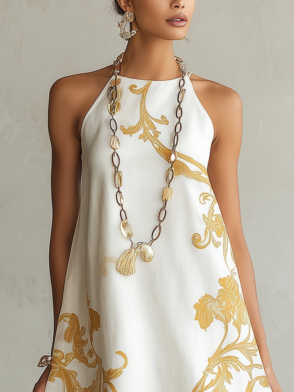 Héloïse mini dress close-up of high sleeveless neckline and gold print