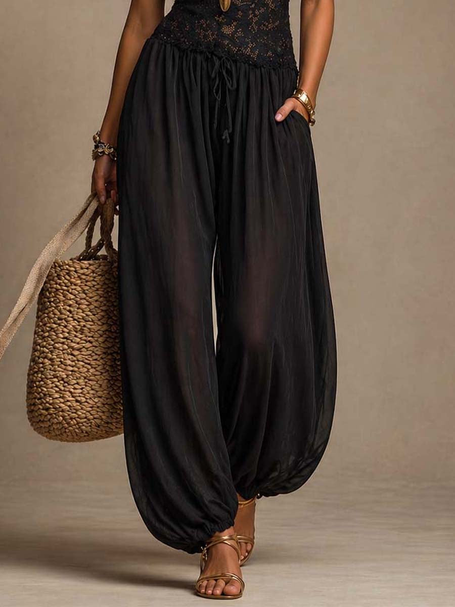 Beatrice harem jumpsuit in black, close-up of drawstring waist and side pocket