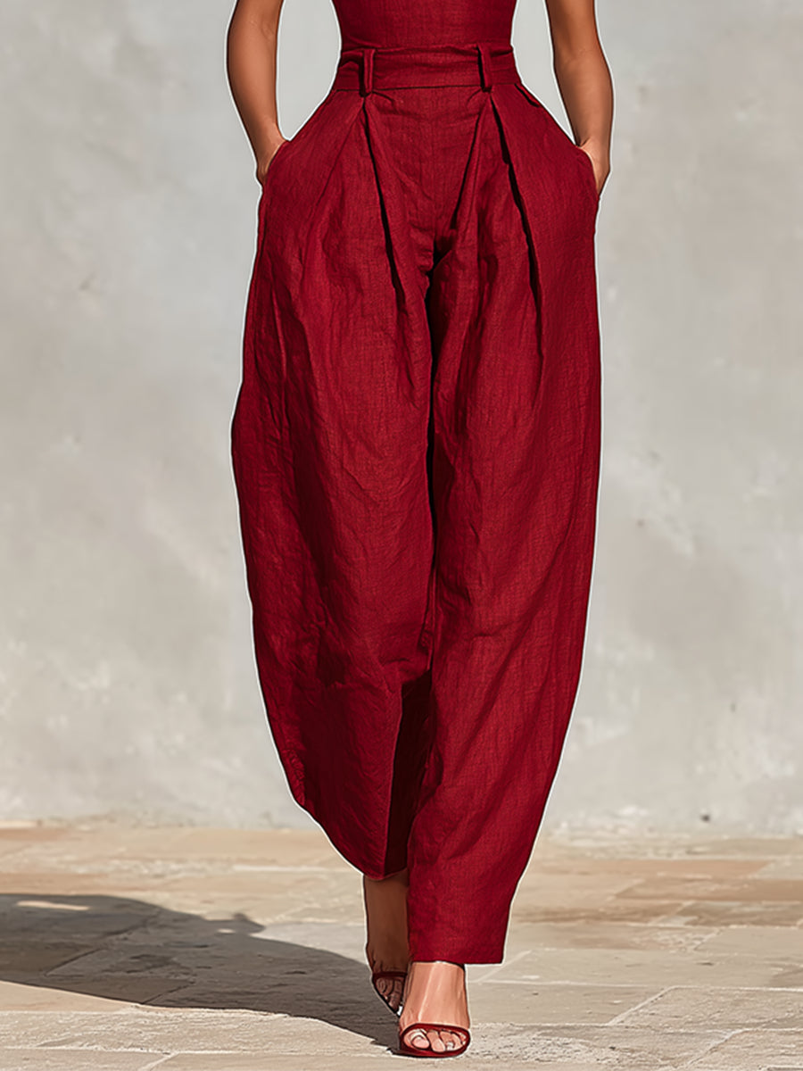 Scarlett jumpsuit in red, close-up of pleated waist and wide legs