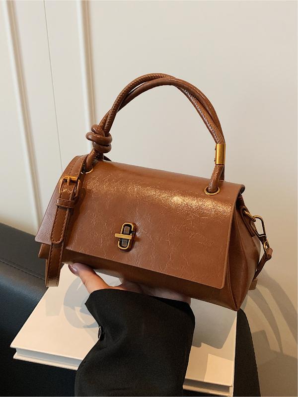 Emma small crossbody satchel in brown, front view with top handle