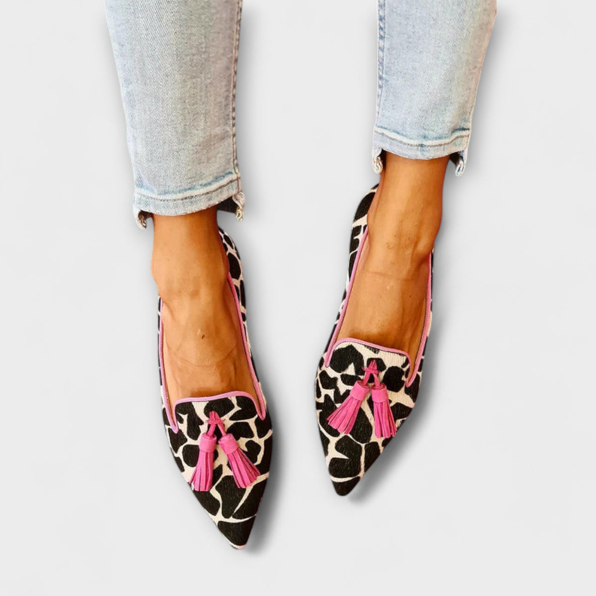 Lucia tassel loafers in animal print with pink trim, worn with cropped jeans