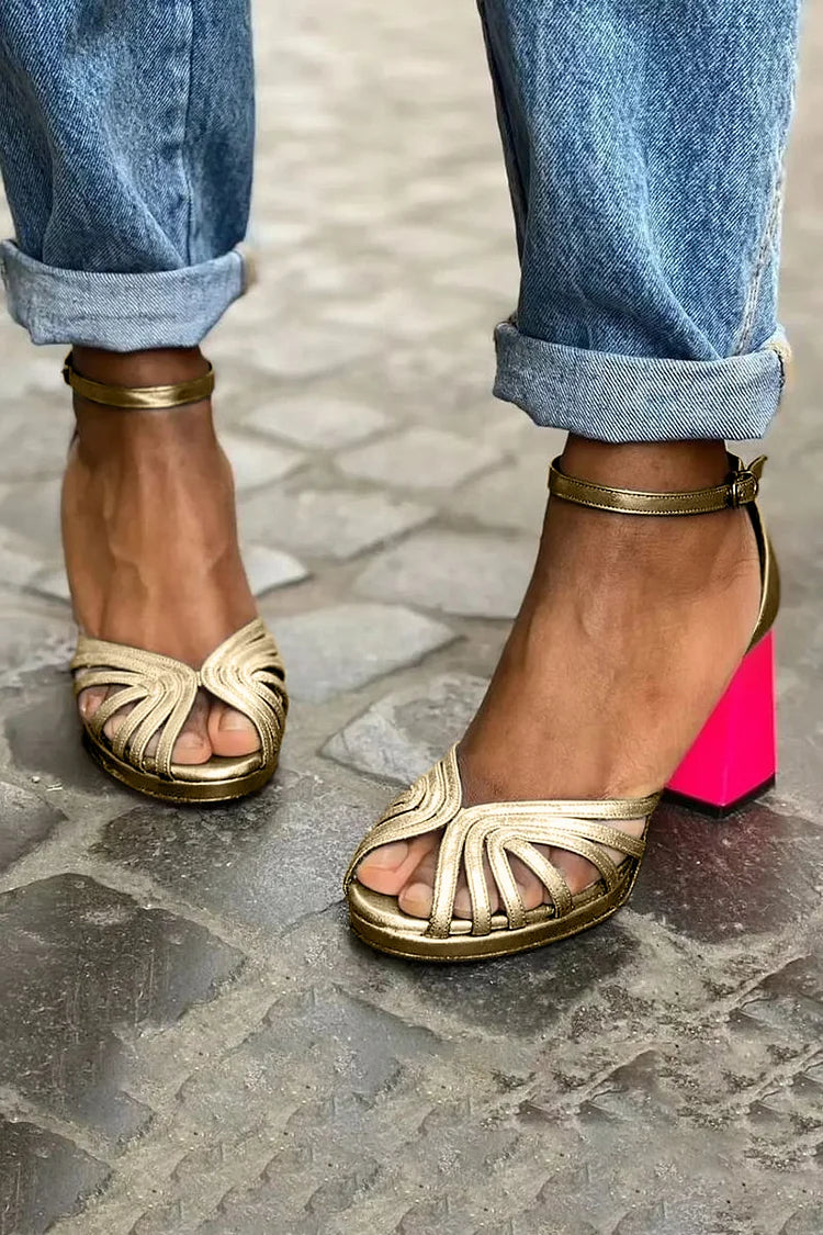 Gold cut-out sandals with pink block heel and ankle strap, worn front view