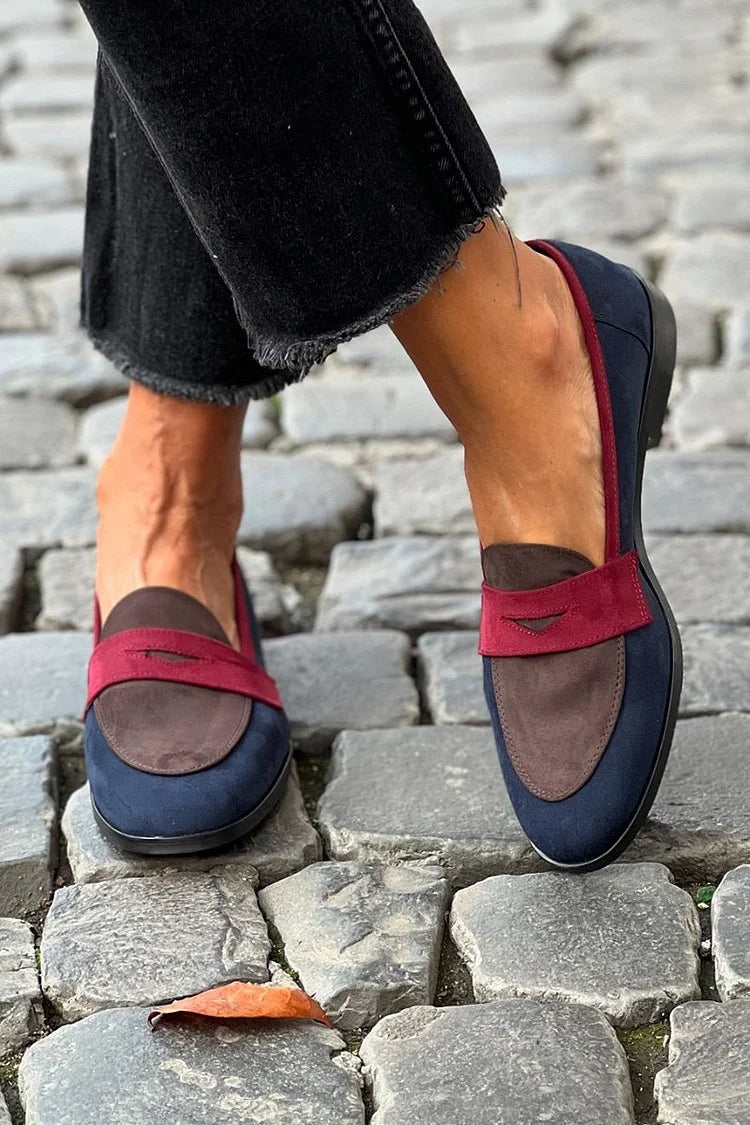 Navy colour-block patchwork round-toe loafers worn on cobbles, side view