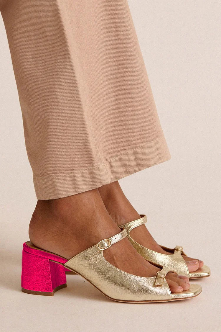 Valentina heeled sandals in gold, worn with beige trousers
