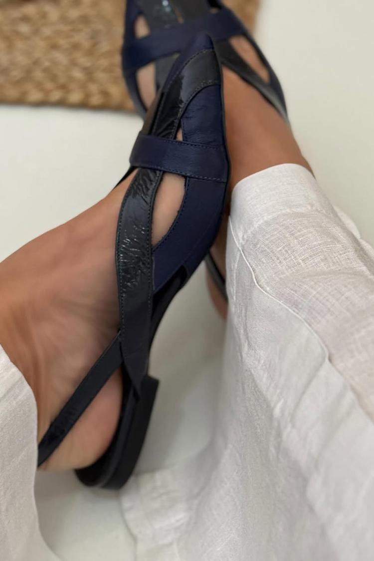 Navy patchwork cut-out ballet flats worn, close-up side view
