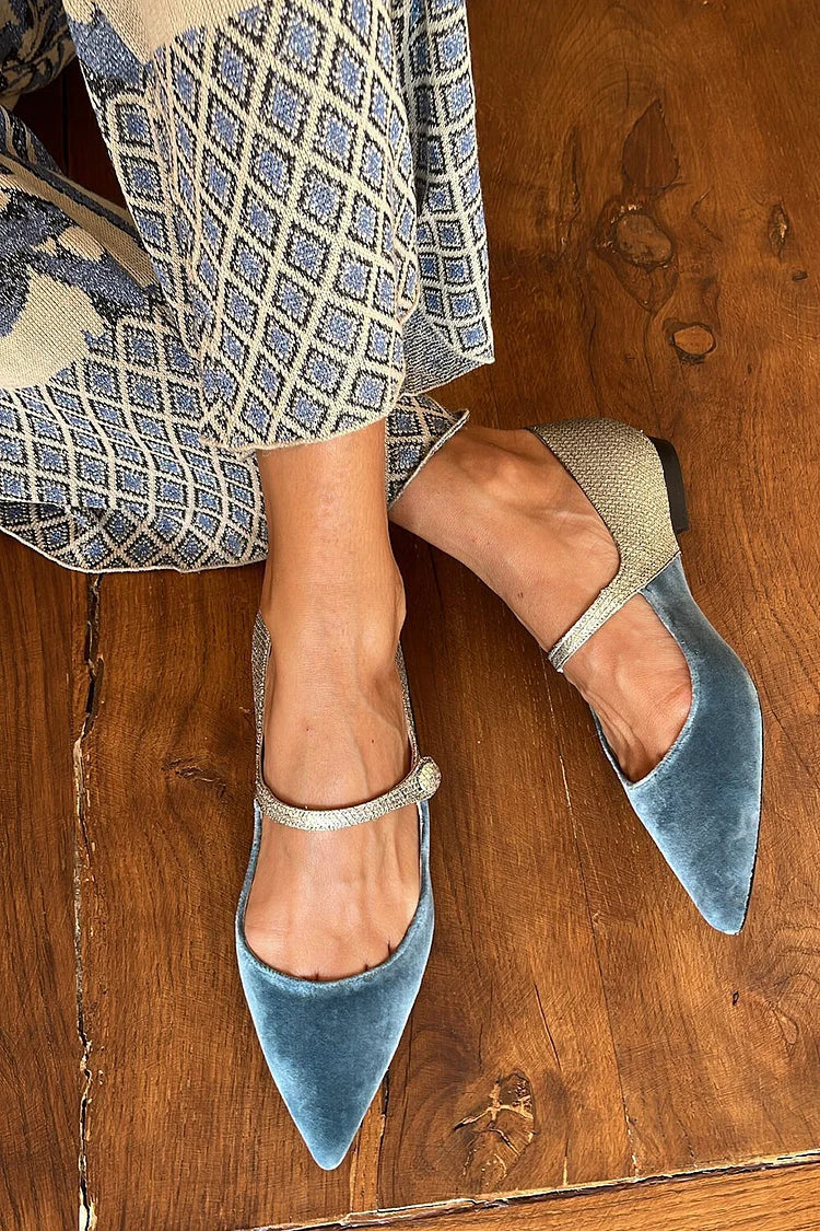 Blue pointed-toe patchwork ballet flats with sparkling instep strap, worn on wooden floor