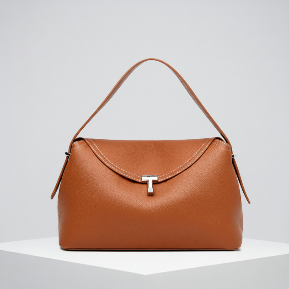La Divine structured handbag in brown, front view with silver T-clasp