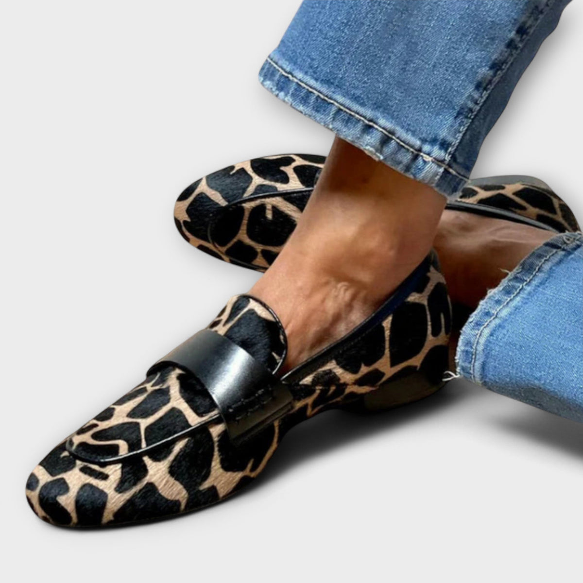 Paula animal-print loafers in black and sand, worn with cropped jeans