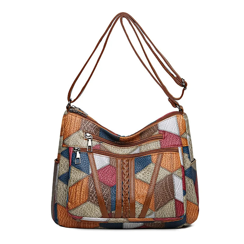 Multicolour patchwork handbag with long tan strap, straight-on view