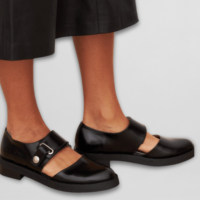 Harriet Mary Janes in black, worn side view with strap and buckle