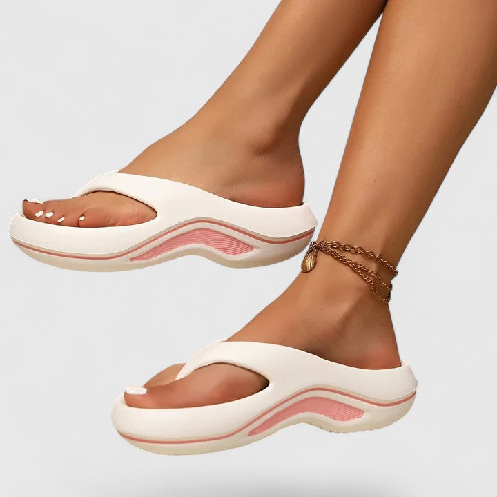 Juliette slide sandals in white with pink trim, worn side view