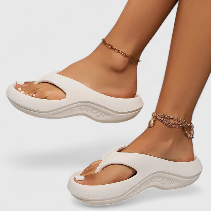 Juliette slide sandals in white, worn front view