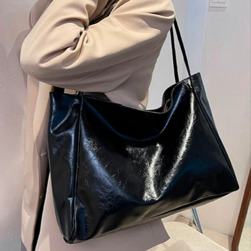 Odessa retro bag in black, side view worn with a beige coat
