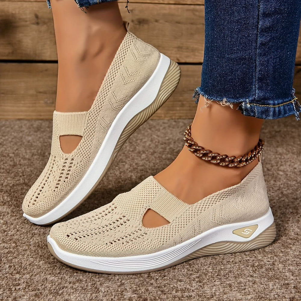 Elara slip-on sneakers in cream, worn side view
