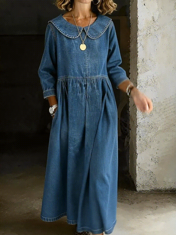 Clara denim dress in blue, worn with hand in side pocket