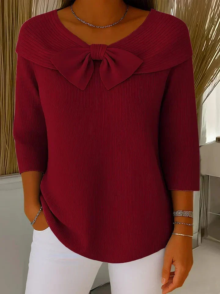 Trinidad bow-detail jumper in red, front view on model
