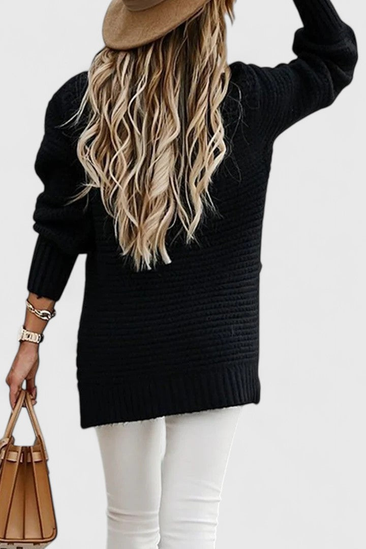 Kalyzziah chunky knit sweater in black, back view with white jeans