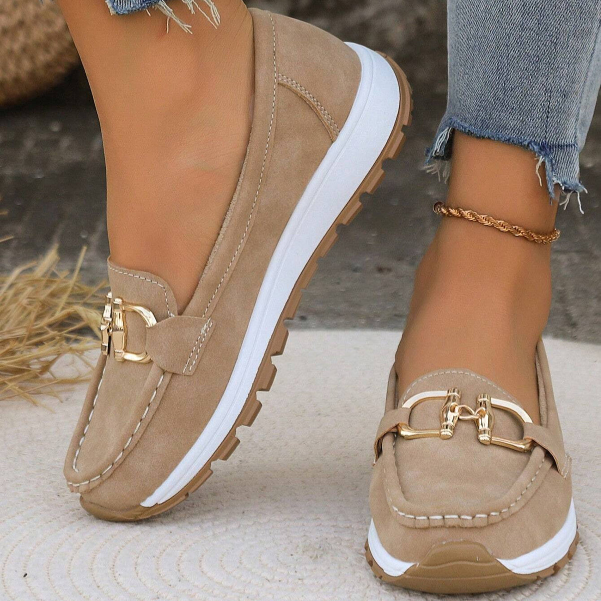 Juliet flat loafers in khaki with gold buckle, worn outdoors