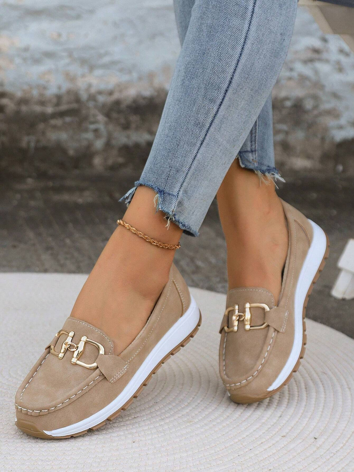 Juliet flat buckle loafers in khaki, worn with jeans front view