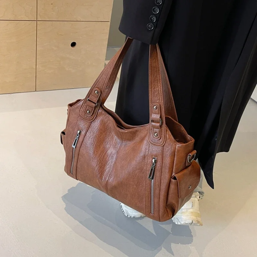 Casual shoulder bag in cognac, carried by the double handles