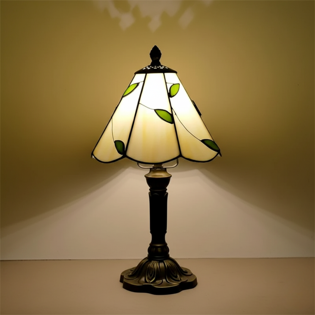 Blowing Wind stained-glass table lamp with green leaf shade, lit front view