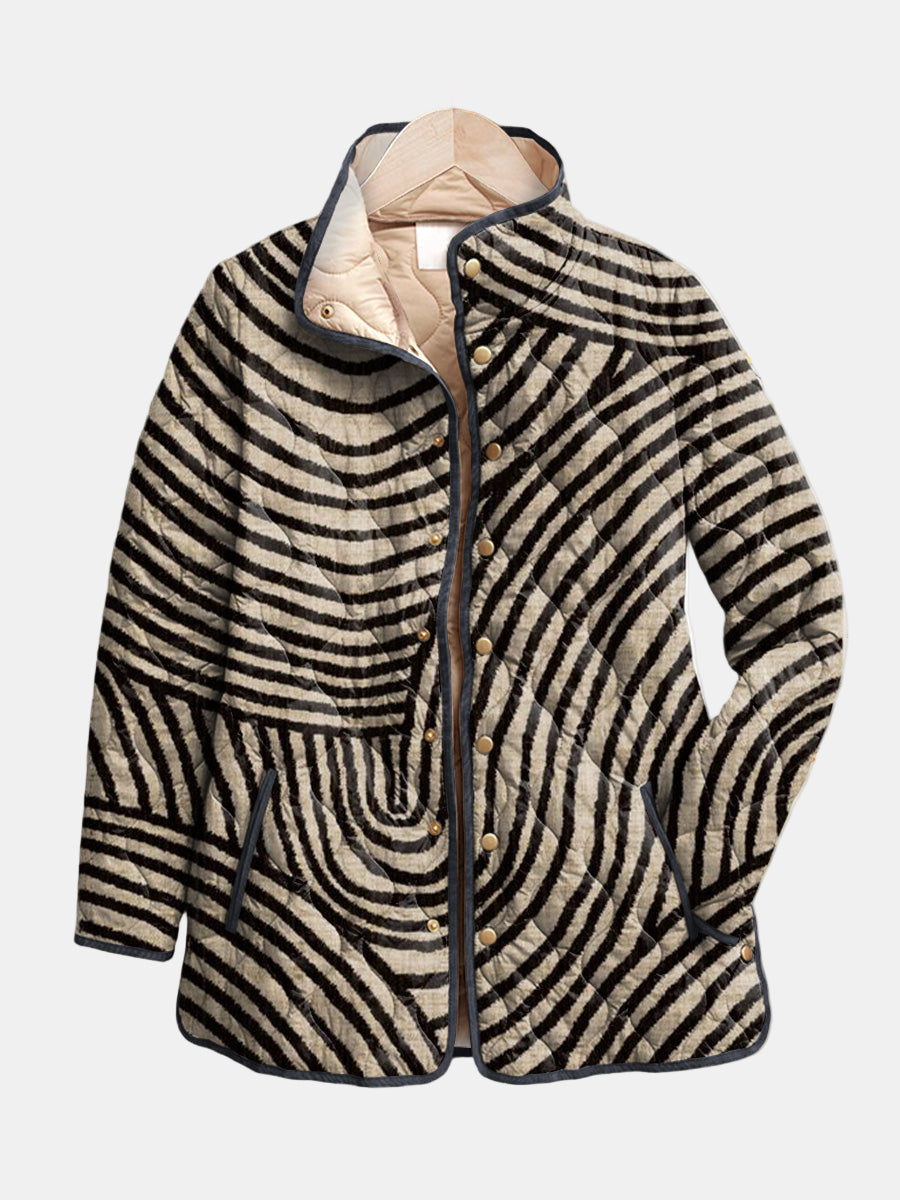 Inaya quilted jacket in black and cream circle print, front view with buttoned placket