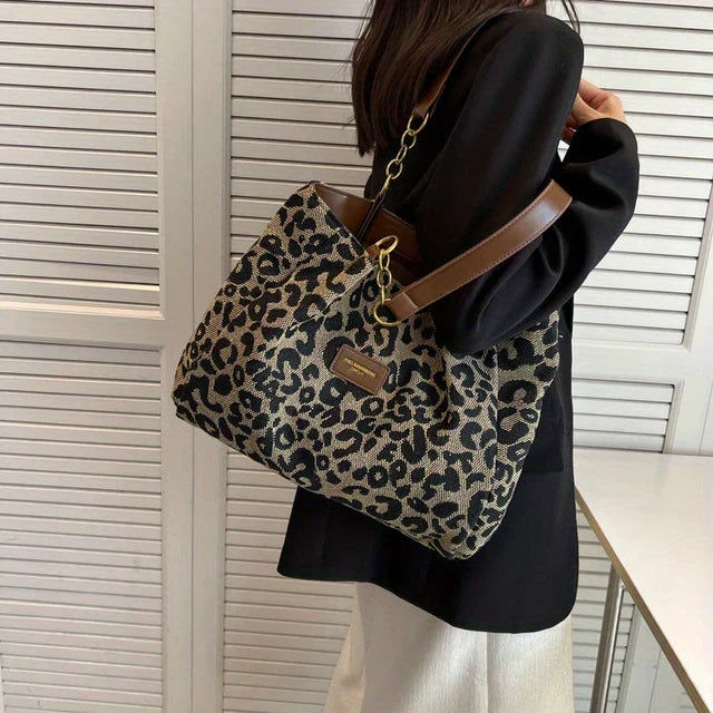 Tavira leopard tote bag carried on the shoulder with a black blazer