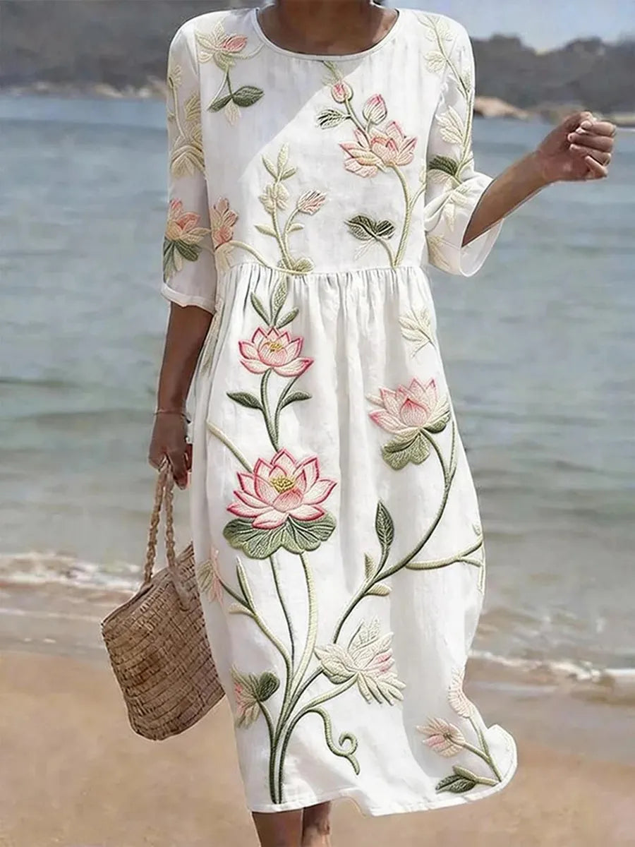 Lotus floral print midi dress in white, full-length front view on the beach