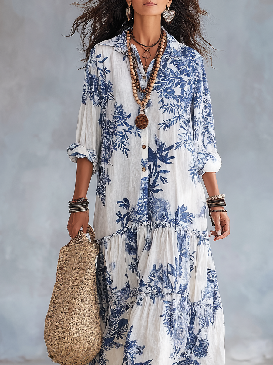 Detail of tiered skirt and floral print on white maxi dress