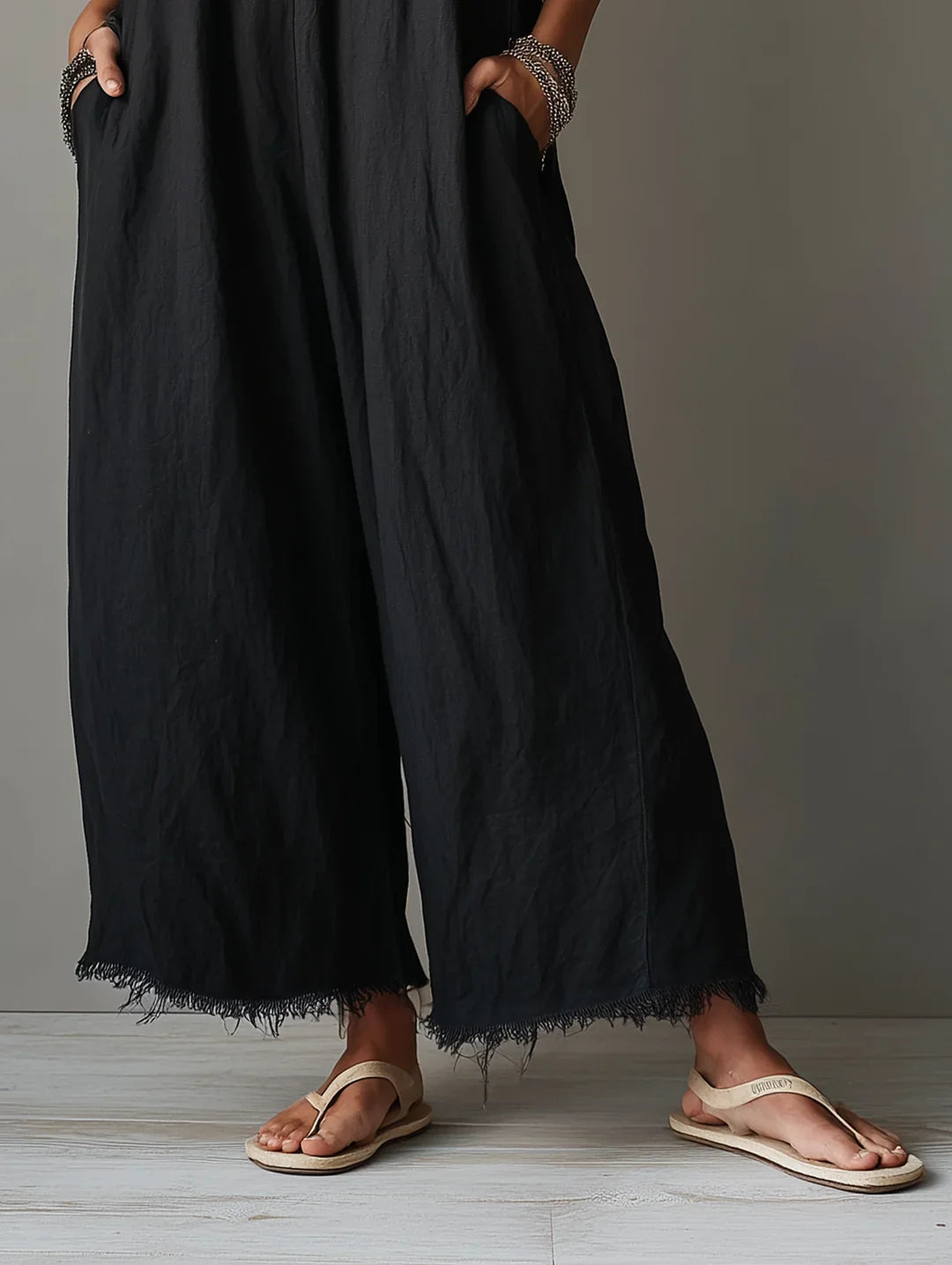 Léa jumpsuit in black, detail of frayed wide-leg hems and side pockets