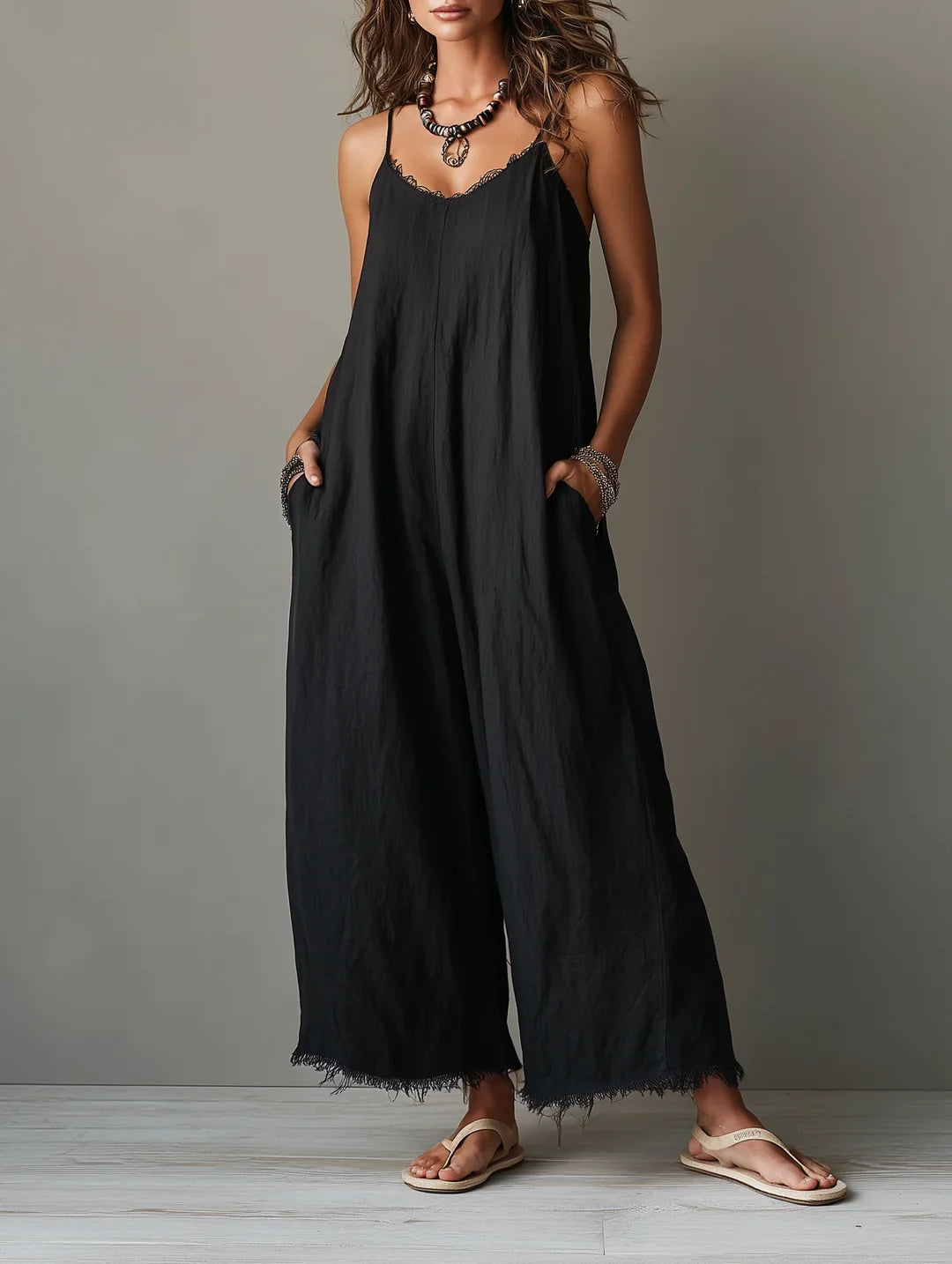 Léa minimalist jumpsuit in black, full-length front view with wide legs